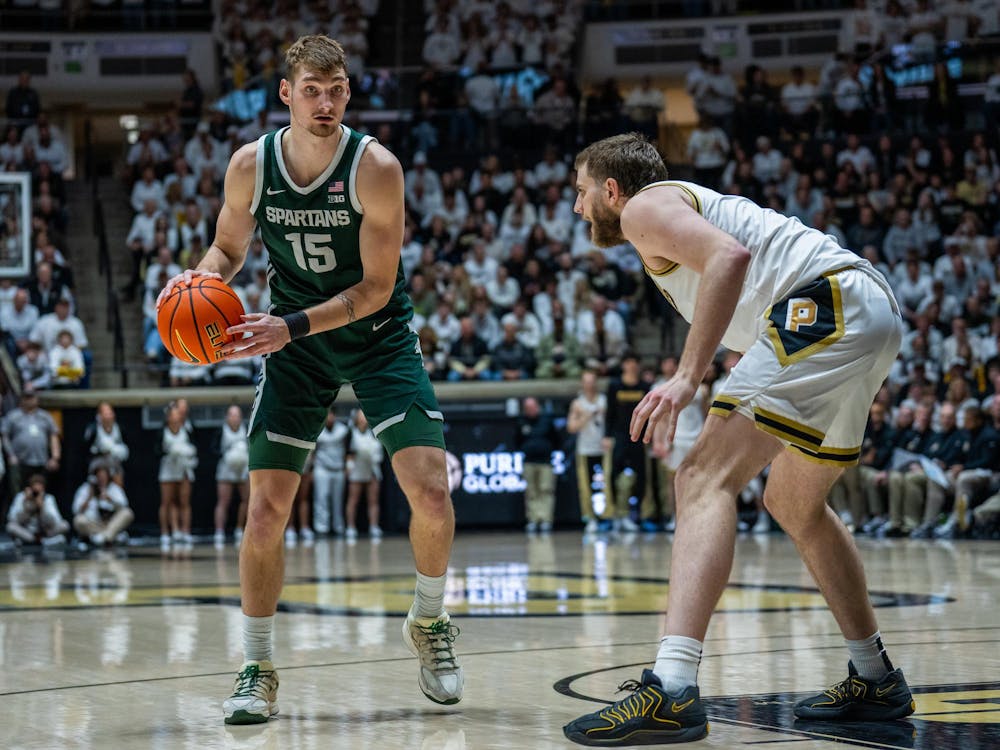MSU senior center Carson Cooper (15) faces off against Purdue's senior center Oscar Cluff (45) at Mackey Arena in West Lafayette, Indiana on Thursday, Feb. 26, 2026. MSU won 76-74.