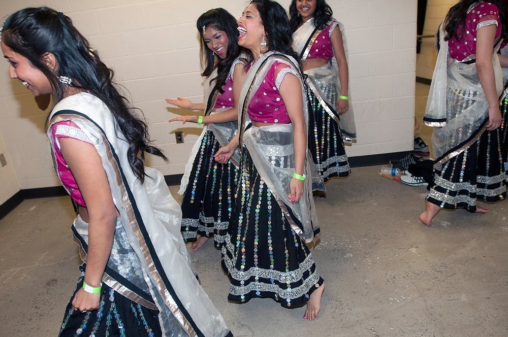 <p>From left to right, nutrition sophomore Sapna Bhalsod, media and communications sophomore Abhilasha Singh and kinesiology sophomore Aretha Narayan practice before going on stage for their performance in the Satrang dance production April 5, 2014, at the Wharton Center.  The girls are members of the "Dirty South" dance group. Allison Brooks/The State News</p>