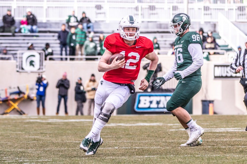 Redshirt freshman quarterback Rocky Lombardi (12) runs up field during the annual Green and White spring game on April 7, 2018 at Spartan Stadium. White defeated Green, 32-30.