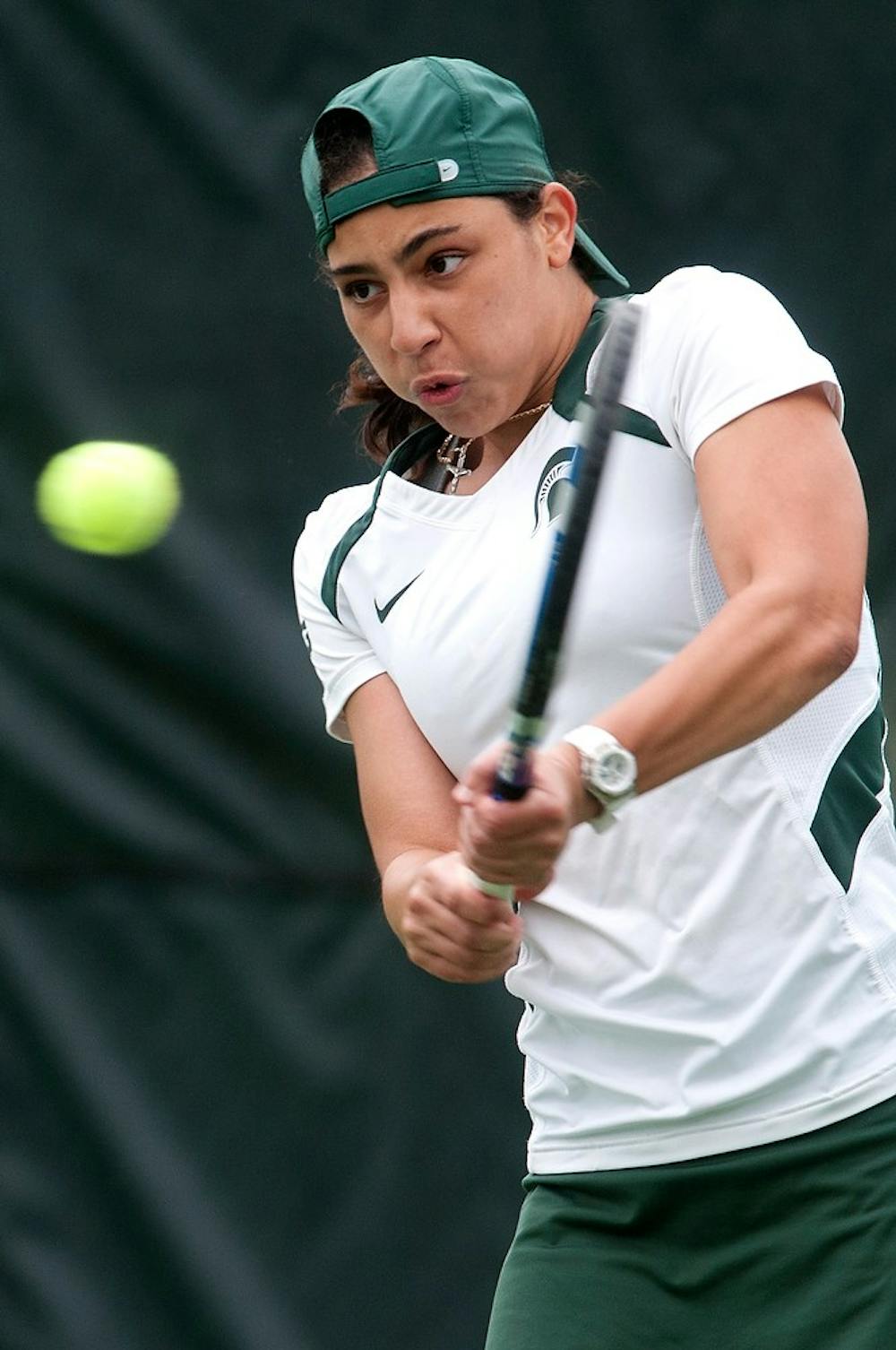 <p>Sophomore Athena Trouillot plays in a match on Sept. 13, 2014, at the outdoor tennis courts on Wilson Rd. Trouillot won her first match of the day in two sets. Jessalyn Tamez/The State News </p>