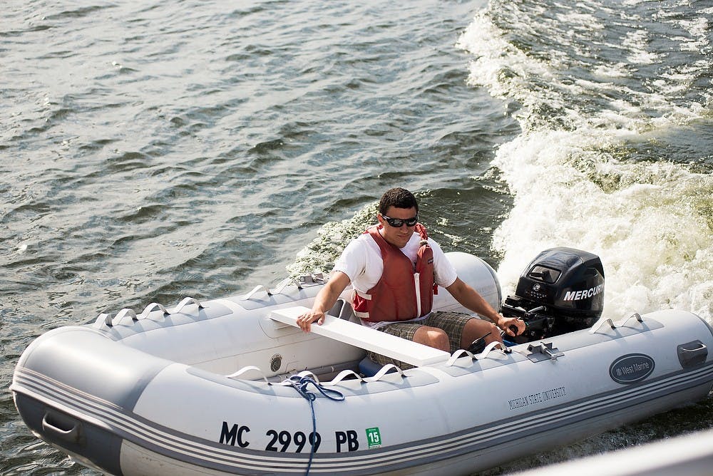 <p>Alumnus Peter Rocco drives a raft June 26, 2014, at the Sailing Center located off the shore of Lake Lansing. Rocco has worked for the center for 3 years. Hayden Fennoy/The State News</p>