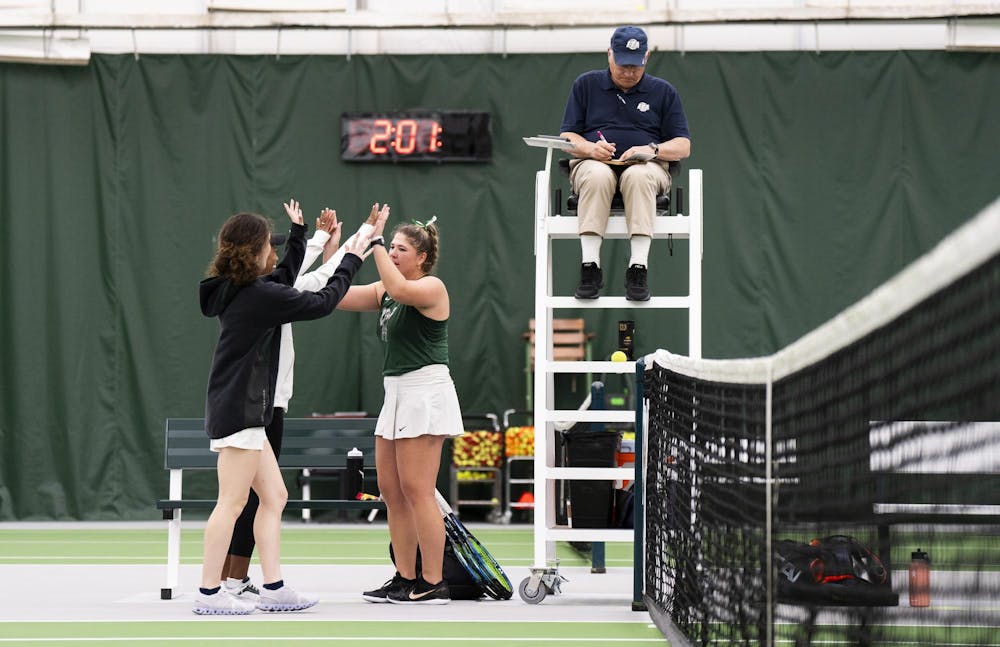 MSU graduate student Nicole Conard celebrates her win with her friends against Purdue junior Tara Katarina Milic at the MSU Tennis Facility on March 30, 2024.