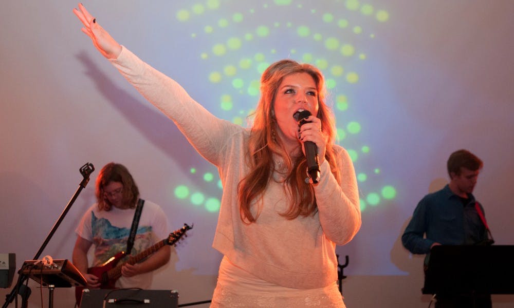 <p>Singer Leah Wise performs a song of praise during Element church service on Oct. 4, 2015, in the Kellogg Center. </p>