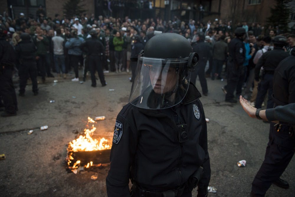 A Michigan State Police officer looks on following the celebration of MSU's victory over Duke in the Elite Eight at Cedar Village Apartments on March 31, 2019. MSU will play Texas Tech in the Final Four in Minneapolis on Saturday, April 6. (Nic Antaya/The State News)