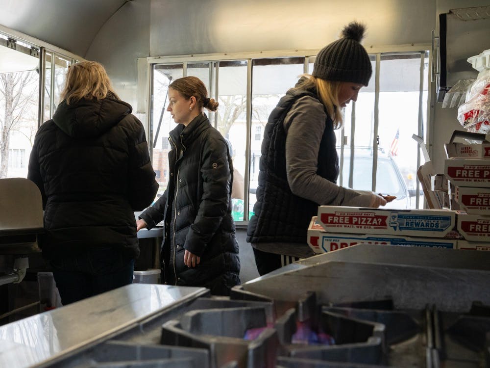 <p>Volunteers for the student organization Homeless Humanity help volunteers from Homeless Angels distribute food to those who need them in downtown Lansing on March 24, 2024.</p>