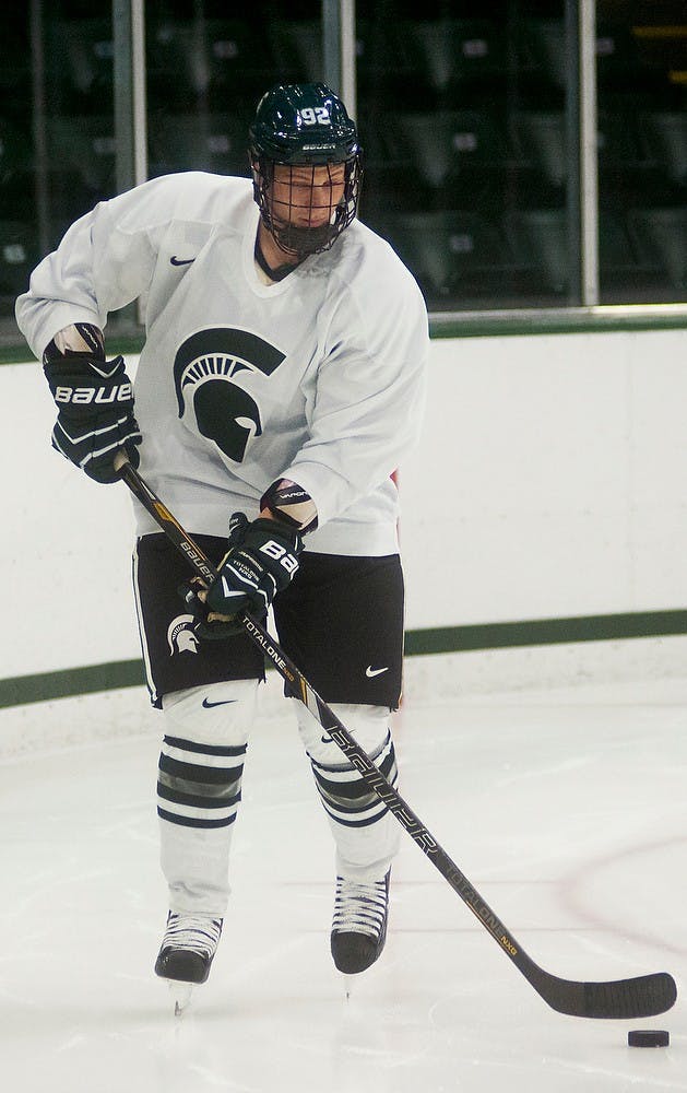 	<p>Sophomore forward David Bondra skates down the ice with a puck during practice after media day, Sept. 25, 2013, at Munn Ice Arena. The annual Green and White Game is scheduled for Oct. 5, 2013, before an exhibition against Western Ontario on Oct. 9. Danyelle Morrow/The State News</p>