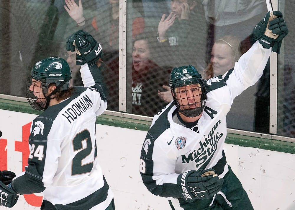 Senior forward Chris Forfar, right, celebrates his first period goal with redshirt freshman Justin Hoomaian, No. 24, next to him. The Buckeyes defeated the Spartans, 3-1, Saturday, Dec. 1, 2012, at Munn Ice Arena. Justin Wan/The State News