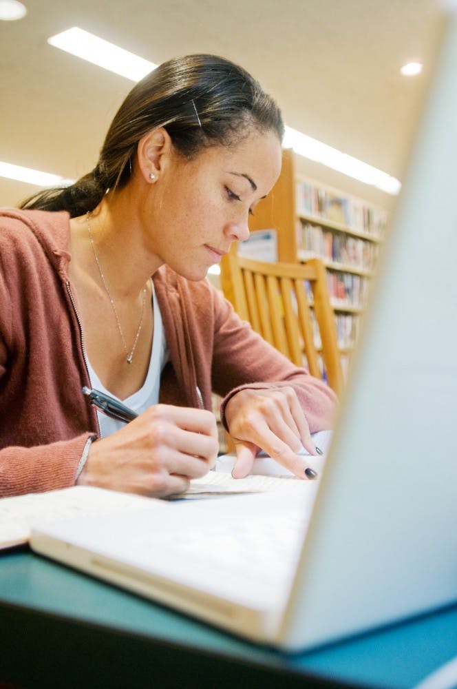 Brittany Oneal, MSU Graduate student, secludes herself in a corner on Wednesday at the East Lansing Public Library, 950 Abbot Road. The library is currently offering free library cards for MSU students valid for a three-year period. Mo Hnatiuk/The State News