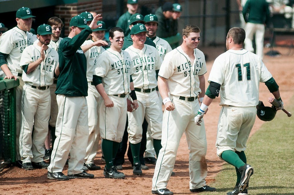 <p>The Spartan dugout celebrates a home run by junior catcher/first baseman Blaise Salter, 11, during the game against Siena on April 6, 2014, at McLane Baseball Stadium at Old College Field. The Spartans defeated the Saints, 5-1. Danyelle Morrow/The State News</p>