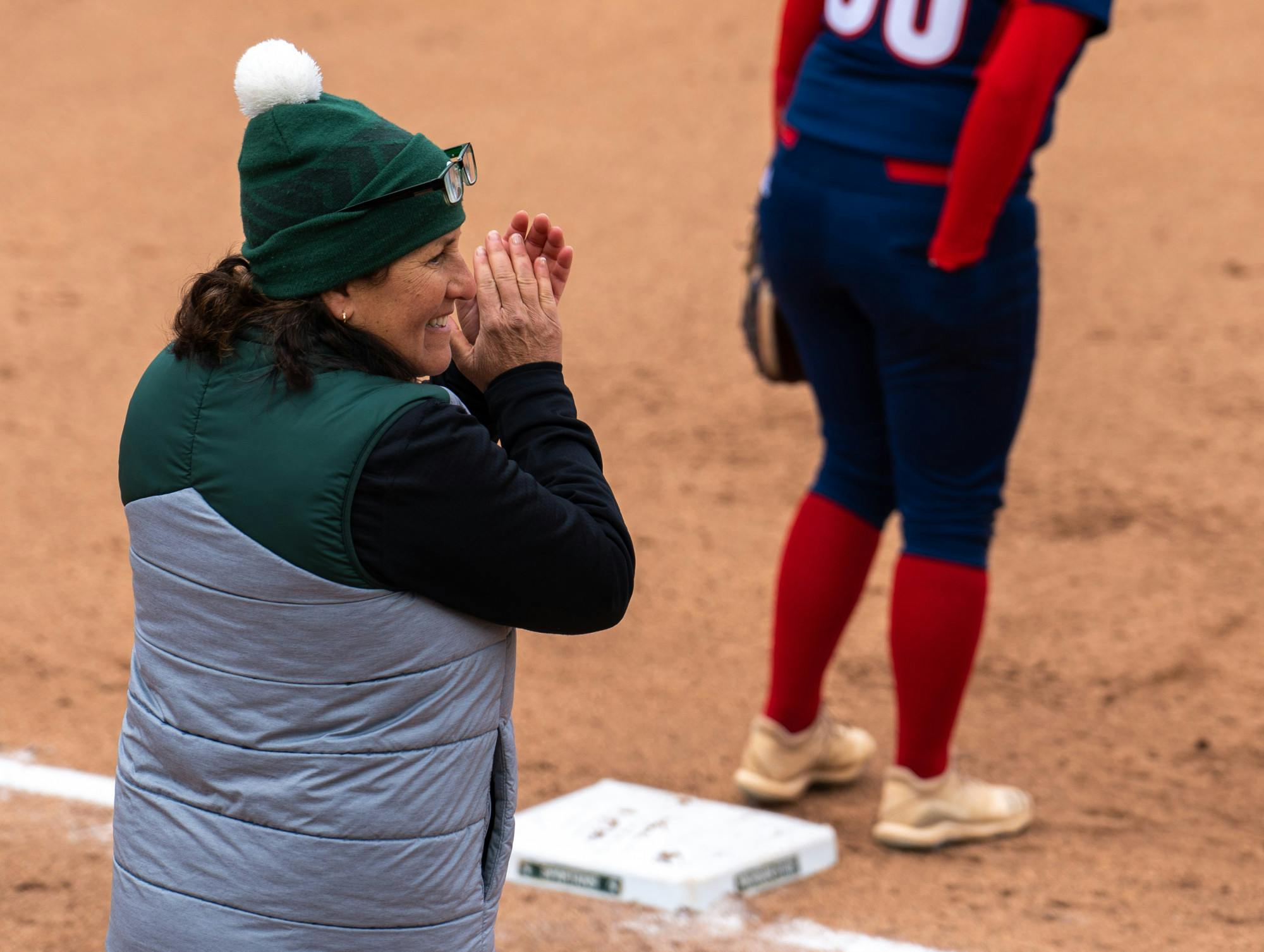 <p>MSU coach Jacquie Joseph claps as a player gets on base during the sixth inning. The Spartans shut out the Titans, 2-0, in the first game of their doubleheader on March 29, 2022. </p>
