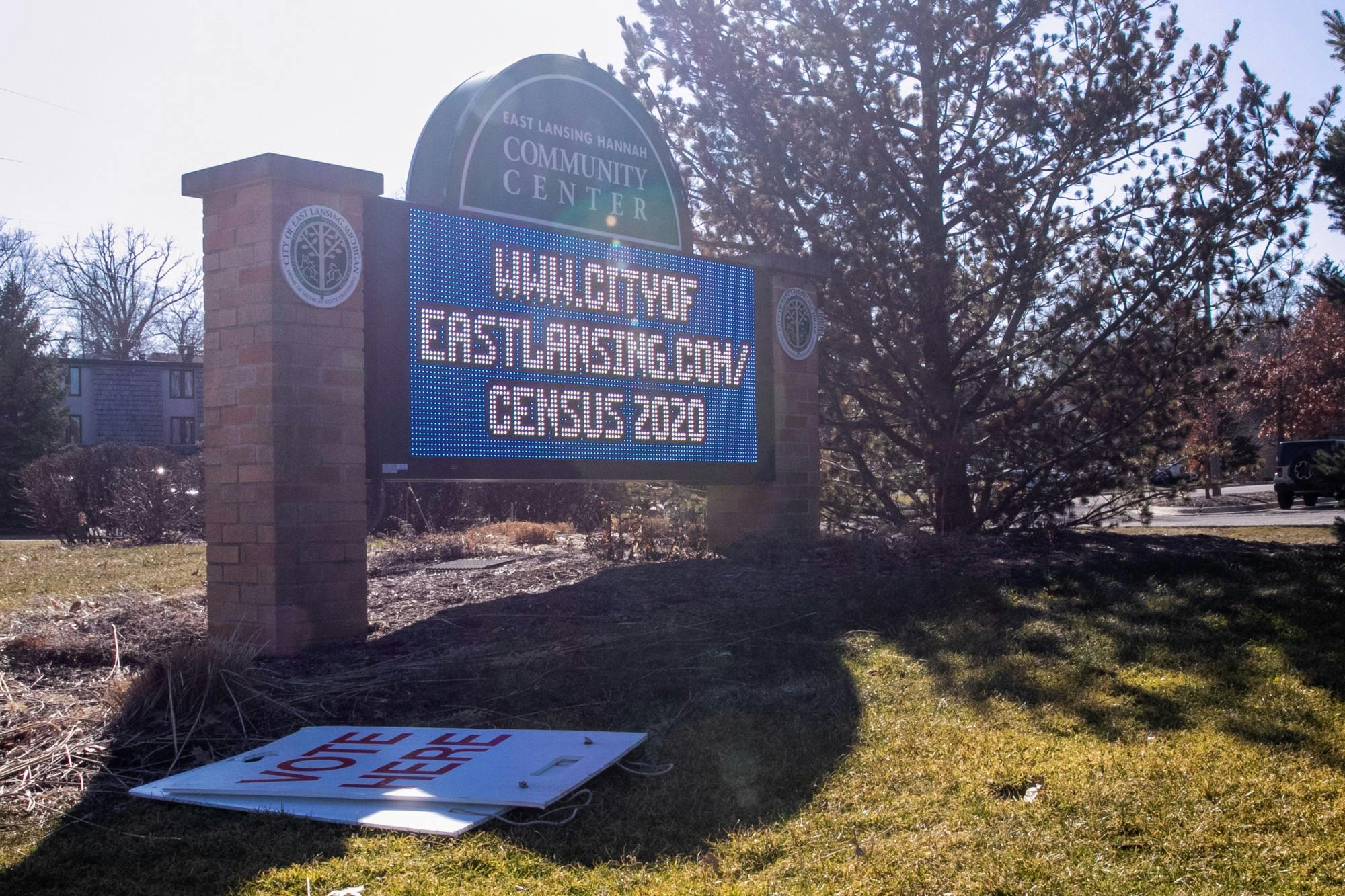 <p>A &quot;Vote Here&quot; sign sits on the ground in front of the Hannah Community Center sign during the election March 10, 2020.</p>