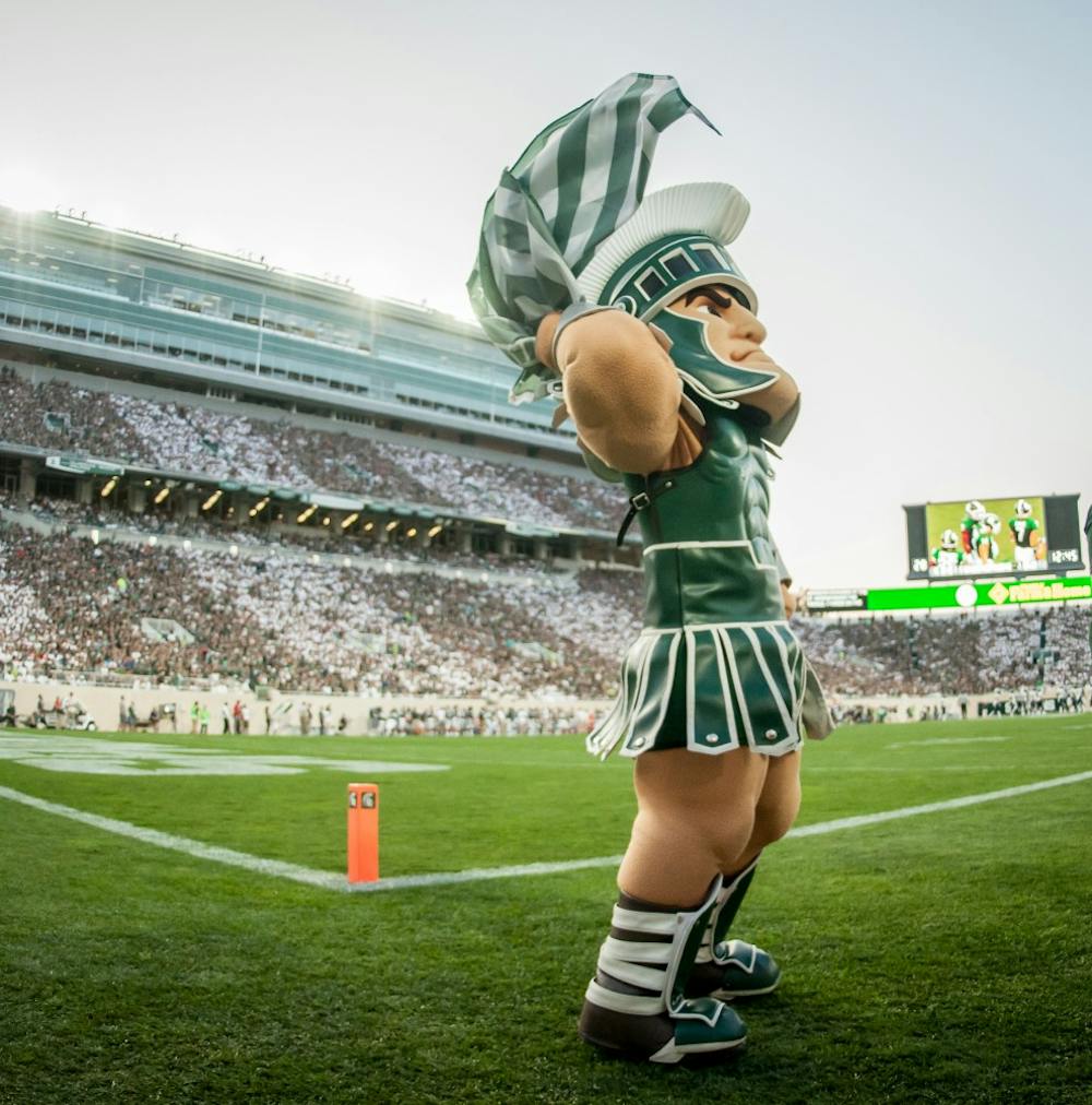 Sparty waves a Spartan flag towards the crowd during the game against Utah State on Aug. 31, 2018 at Spartan Stadium. The Spartans defeated the Aggies 38-31.