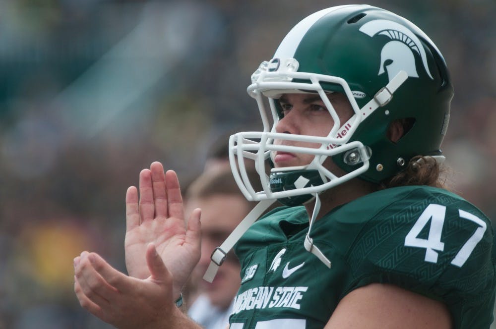 Freshman linebacker Ryan Armour (47) claps from the sidelines as he watches the team during the game against Michigan on Oct. 29, 2016 at Spartan Stadium. The Spartans were defeated by the Wolverines, 32-23.