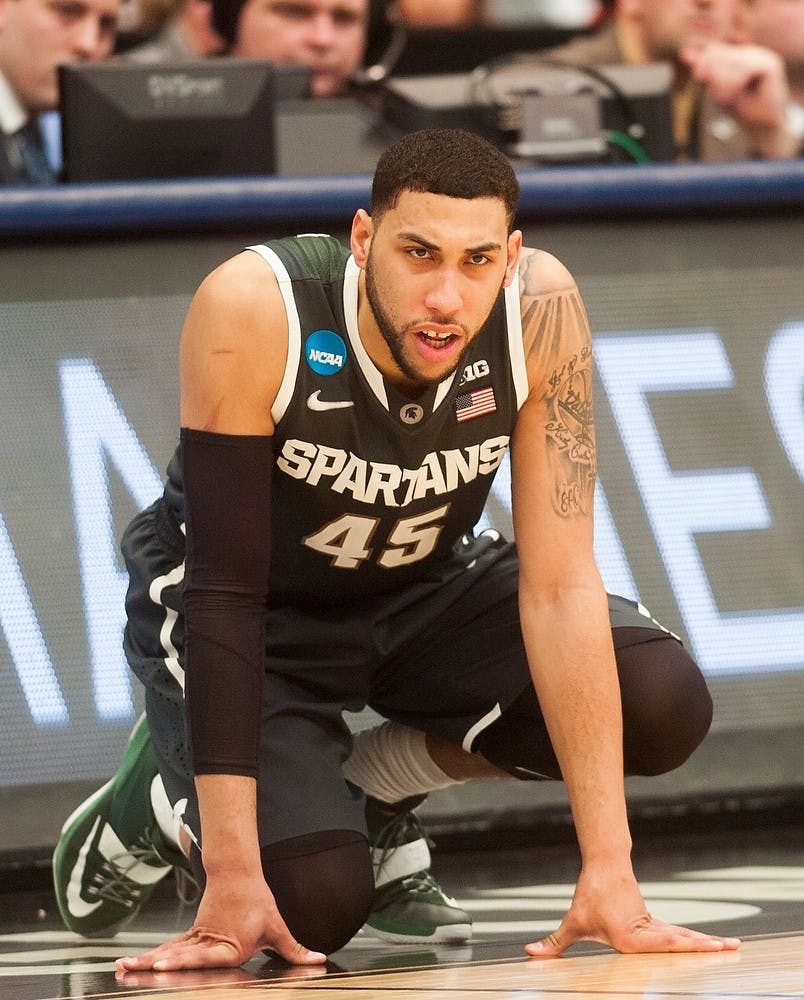 <p>Junior guard Denzel Valentine watches his team play before he comes in off the bench March 29, 2015, during the East Regional round of the NCAA Tournament in the Elite Eight against Louisville at the Carrier Dome in Syracuse, New York. The Spartans defeated the Cardinals in overtime, 76-70. Erin Hampton/The State News</p>