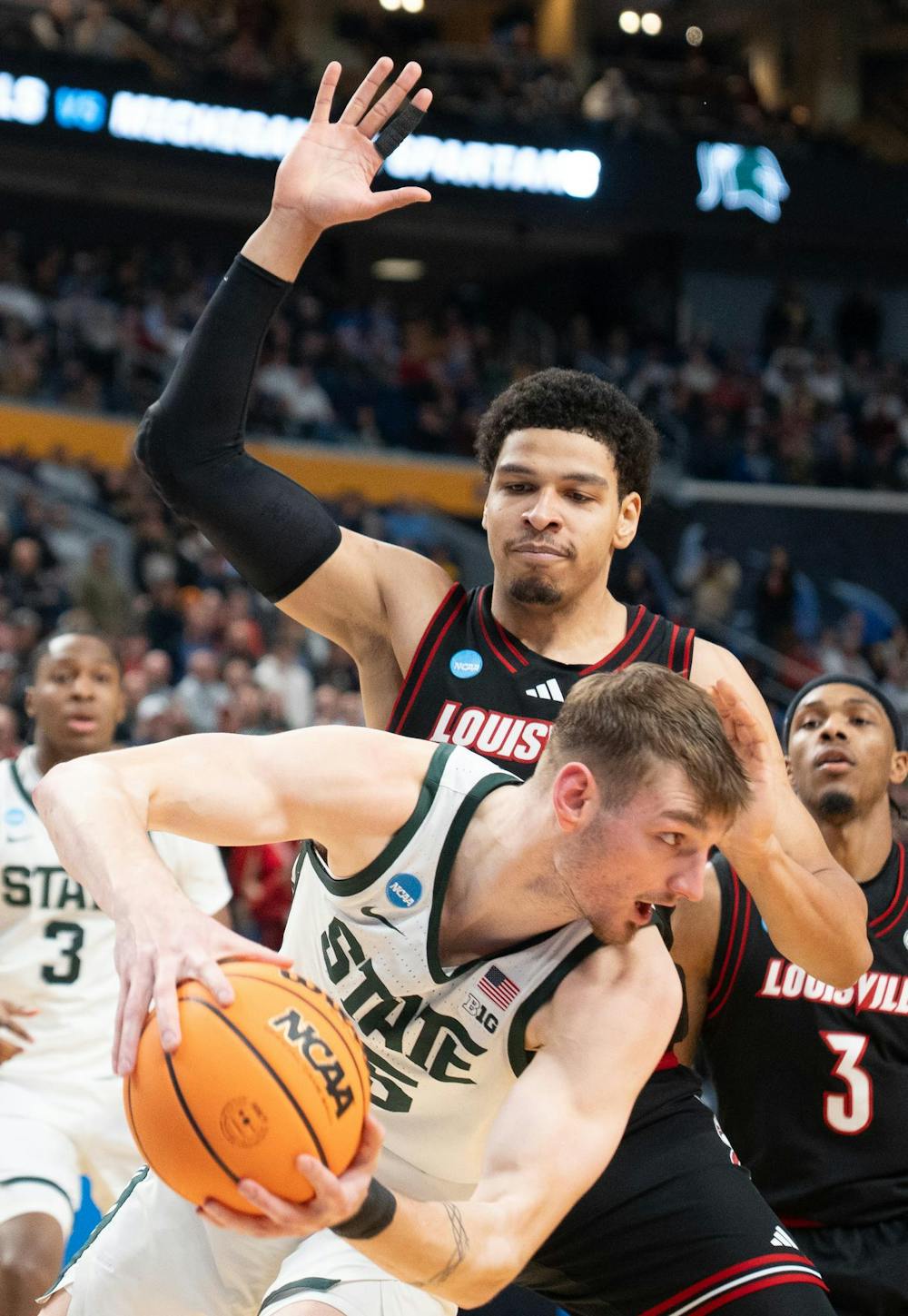 Senior center Carson Cooper (15) protects the ball during the March Madness matchup against University of Louisville at the KeyBank Center in Buffalo, New York on March 21, 2026.