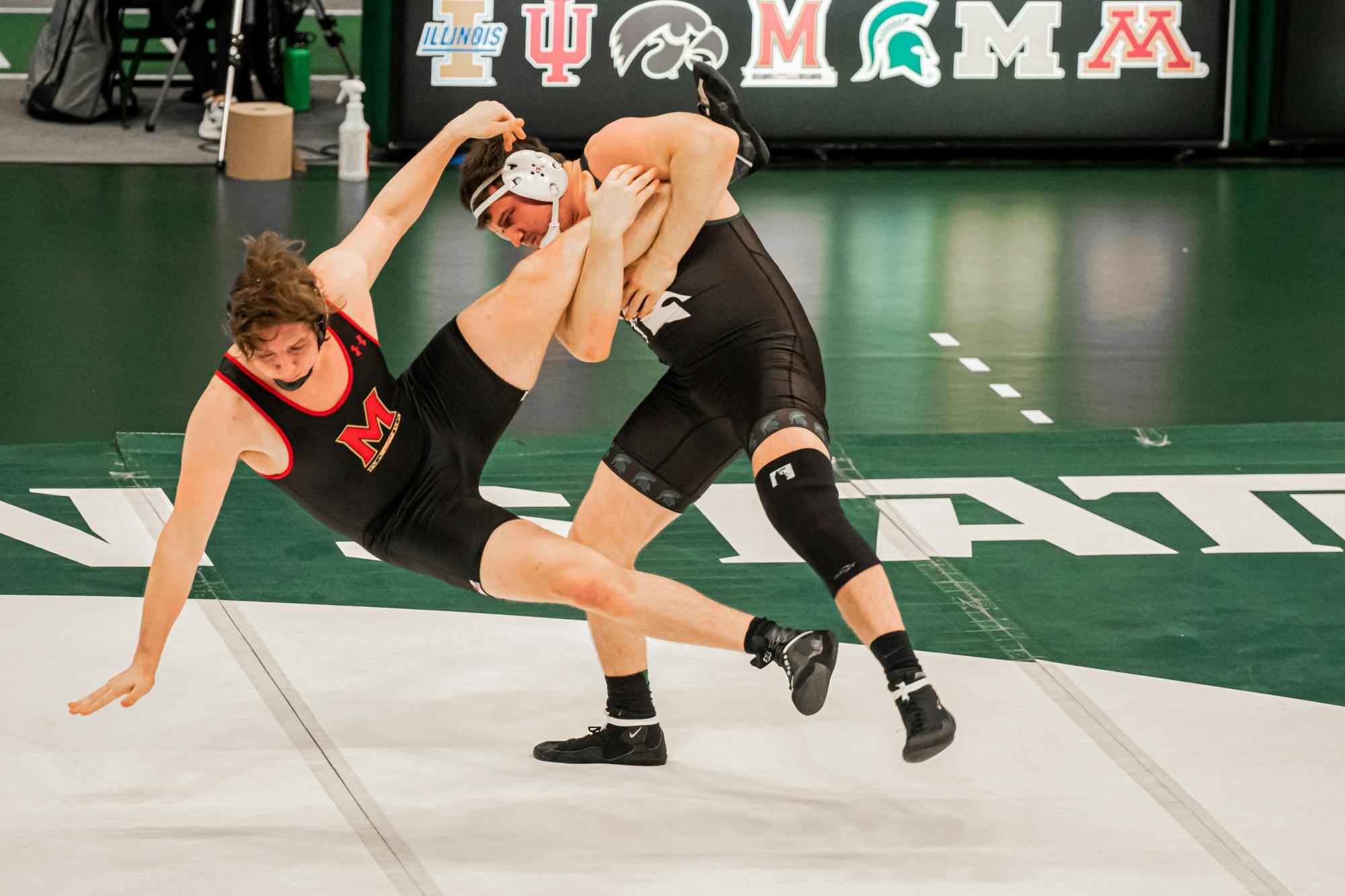 <p>Then-redshirt junior Brad Wilton uses a takedown technique on Maryland then-redshirt freshman Connor Bowes on Jan. 16, 2021. Wilton won the heavyweight bout by technical fall.</p>