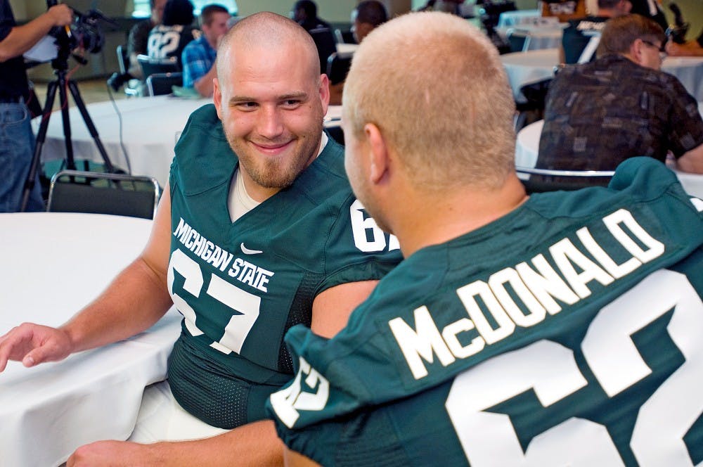 	<p>Fifth year senior offensive guard Joel Foreman, left, and senior offensive guard Chris McDonald enjoy a brief break from inquisitive reporters during Monday&#8217;s media day on the fourth floor of Spartan Stadium.</p>