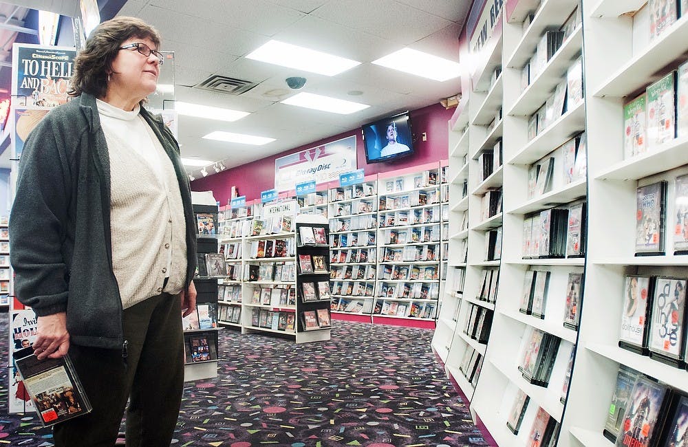 	<p>Haslett resident Susan Russick looks for a newly-released movie at Video to Go, a movie store located in the Frandor Shopping Center, 300 N. Clippert Ave., Suite 18, in Lansing, Tuesday, Jan. 29, 2013. Russick stated that the selection of movies at the store encourages her to shop there instead of online or at a smaller store. </p>