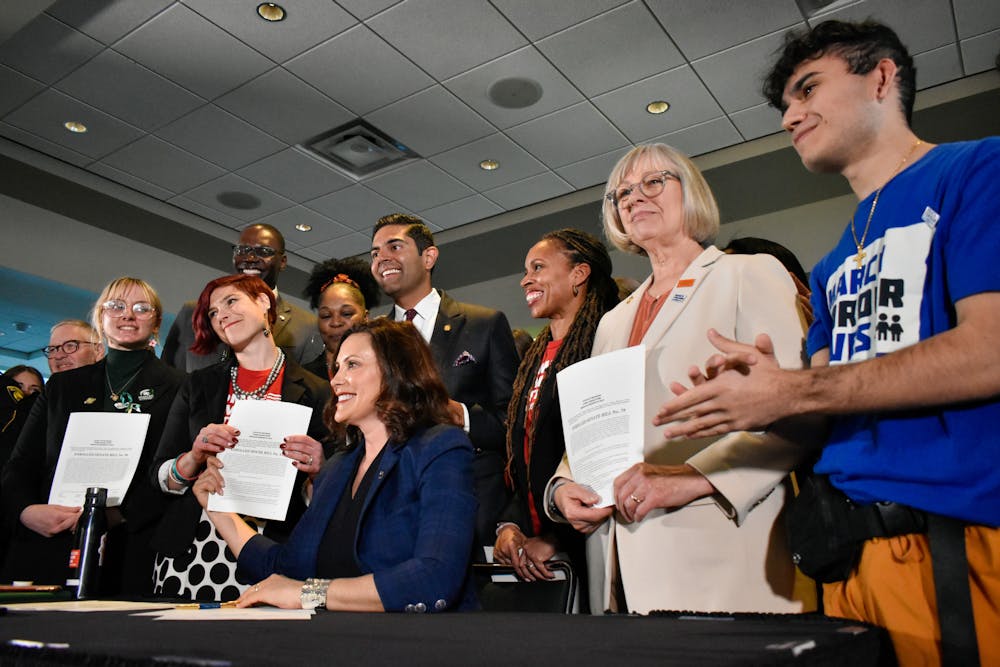 Gov. Gretchen Whitmer signed legislation to require universal background checks for firearm purchases and safe storage of guns during an event at Spartan Stadium on April 13, 2023. (Andrew Roth)