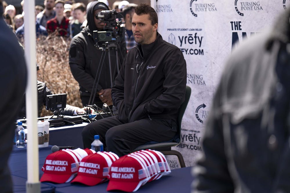Charlie Kirk bites his lip before responding to a question during his "American Comeback Tour" event at Wells Courtyard on April 11, 2025.