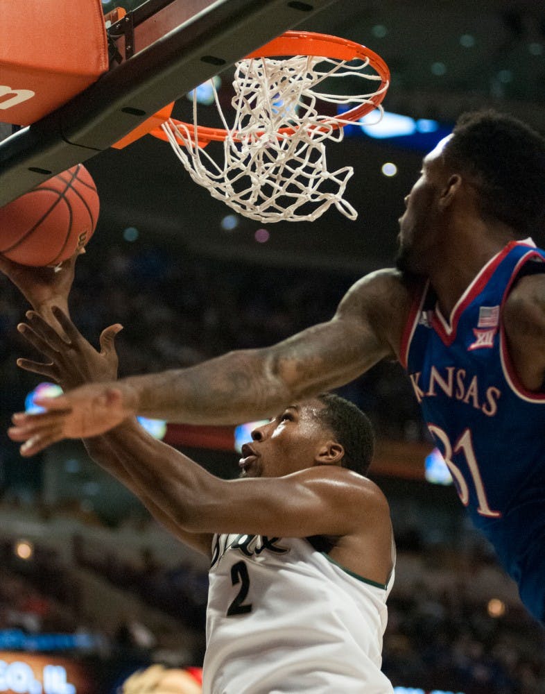 <p>Sophomore guard Javon Bess goes for the lay-up as Kansas forward Jamari Traylor defends on Nov. 17, 2015 at United Center in Chicago during the Champions Classic. The Spartans defeated the Jayhawks, 79-73.</p>