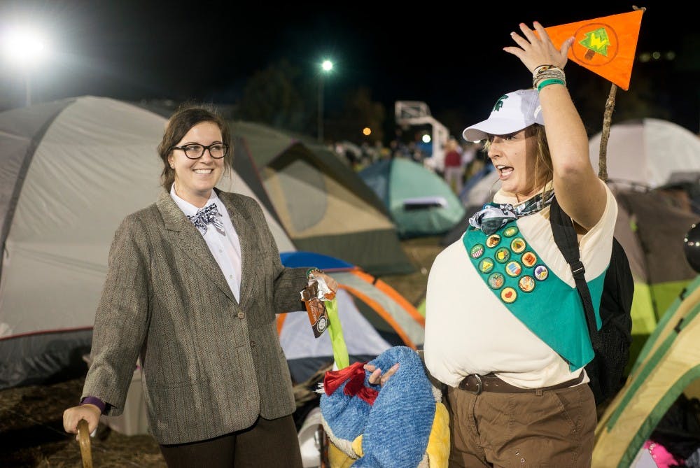 <p>Physiology senior Tori Mutch, left, and animal science senior Morgan Rorah show off their costumes on Oct. 9, 2015, during the Izzone Campout at Munn Field. This annual event consists of students staying throughout the night in hopes of getting lower bowl seating. </p>