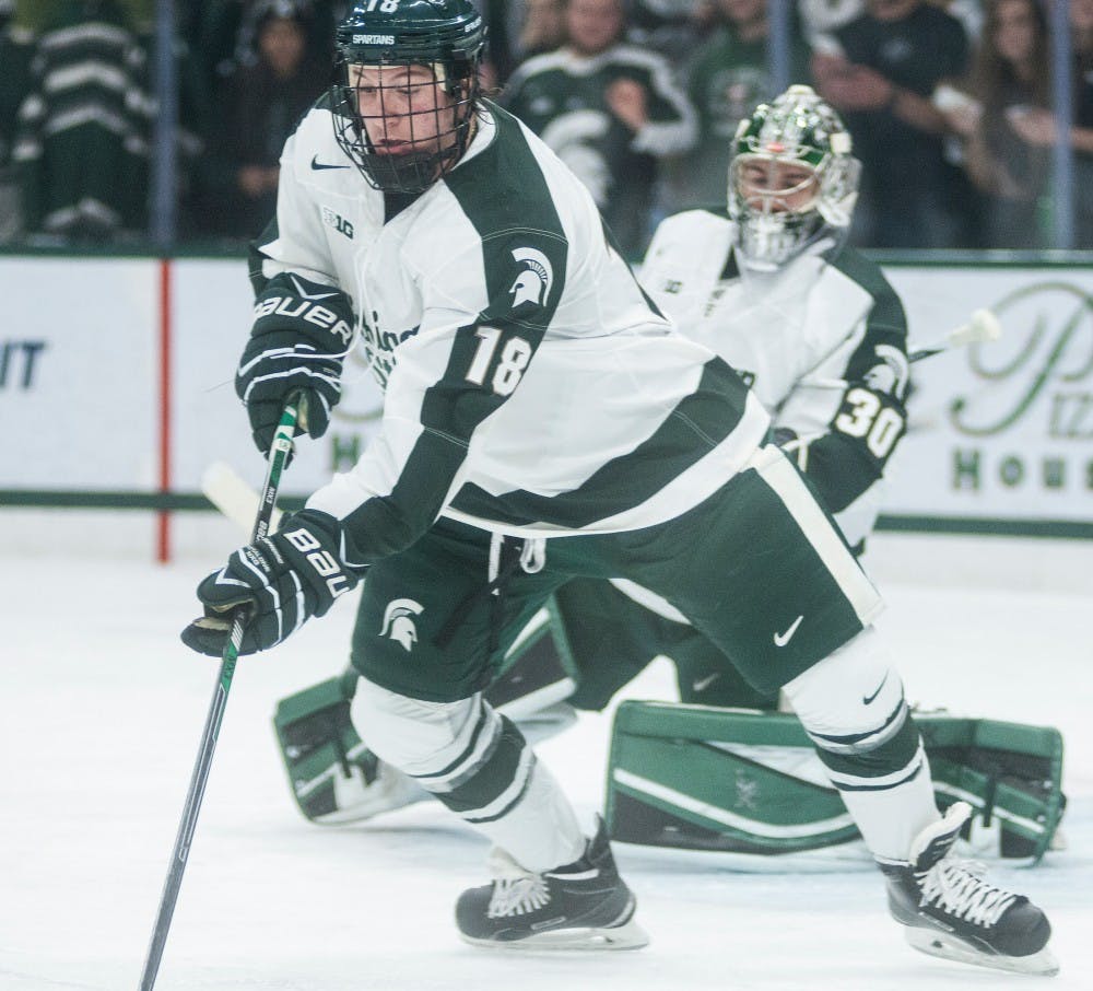 <p>Freshman defender Carson Gatt guides the puck down the ice Nov. 14, 2014, during the game against Boston College at Munn Ice Arena. The Spartans lost to the Eagles, 3-2. Erin hampton/The State News</p>
