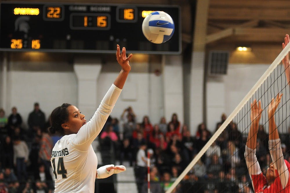 <p>Senior middle blocker/outside hitter Jazmine White leaps for the ball Nov. 22, 2014 during the game against Rutgers at Jenison Field House. The Spartans defeated the Scarlet Knights, 3-0. Dylan Vowell/The State News</p>