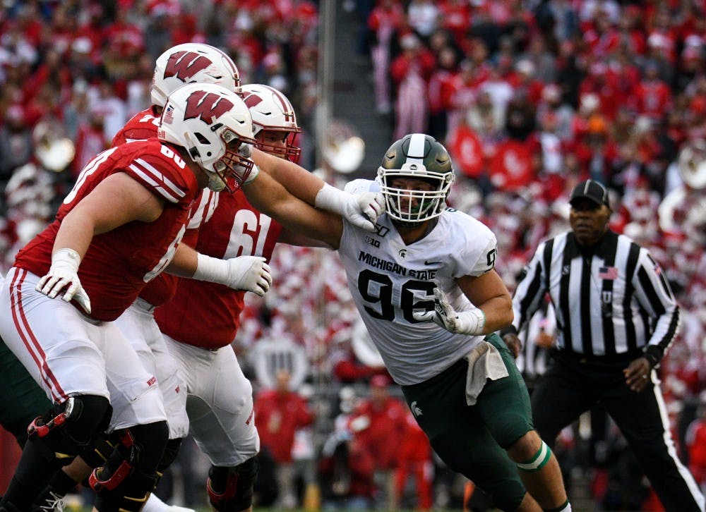 <p>Junior defensive end Jacub Panasiuk (96) pushes back Wisconsin players during the game against Wisconsin at Camp Randall Stadium on October 12, 2019. The Spartans lost to the Badgers 38-0. </p>