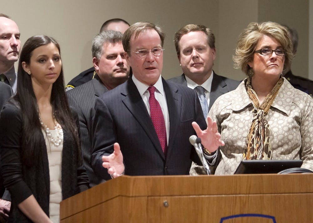 <p>Michigan Attorney general Bill Schuette speaks at a press conference after the sentencing of Raulie Wayne Casteel. On the left is victim Jennifer Kupiec, and at right is victim Loriann Arthur. Photo Courtesy of Gillis Benedict/Gannett News Service</p>