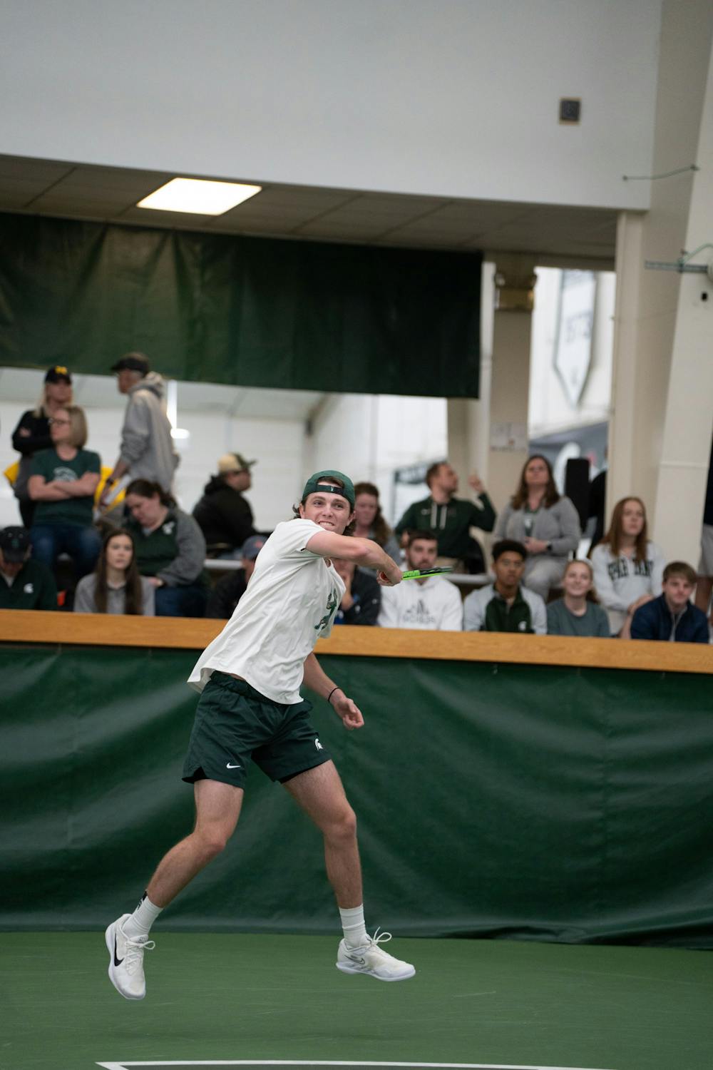 <p>Junior Luke Baylis returns a ball during his singles match against Michigan's junior Gavin Young at the MSU Tennis Center on March 30, 2023. The Spartans lost to the Wolverines 6-1.</p>