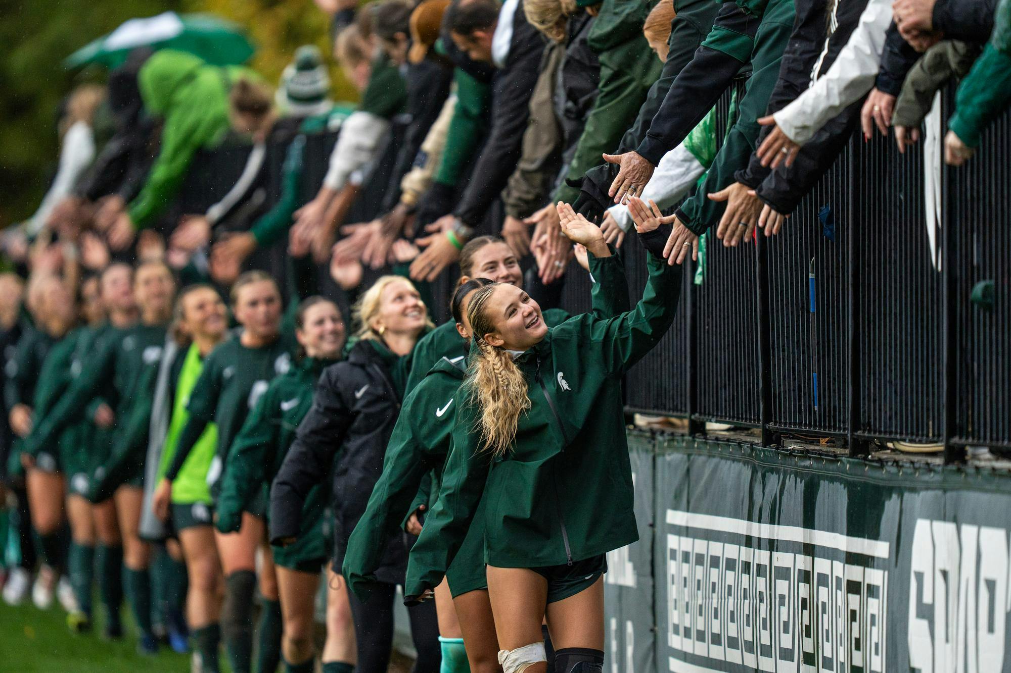 MSU M R-Jr. Emerson Sargeant (19) leads the womens soccer team in their post-game high fives with fans in DeMartin Stadium on Oct. 19, 2025.