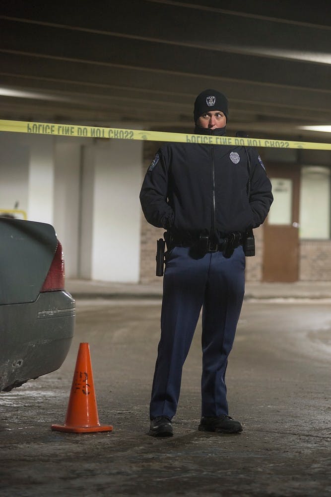 <p>Police units arrive at the scene on Feb. 6, 2015, at the Grove Ramp where a shooting occurred just after midnight. Police had cordoned off the ramp at all entrances, in addition to the entrance to the apartments next door. Emily Nagle/The State News</p>