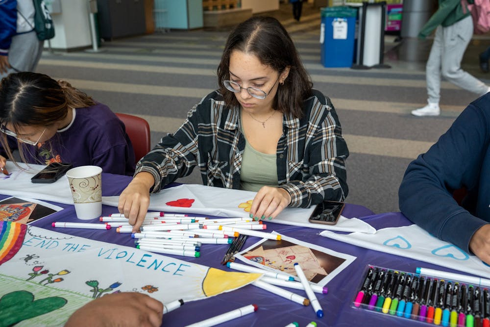 <p>Students paint a bandana during "It's on Us Week," partnering with the Bandana Project to raise awareness for sexual violence on April 5, 2023, in Brody Square Atrium.&nbsp;</p>