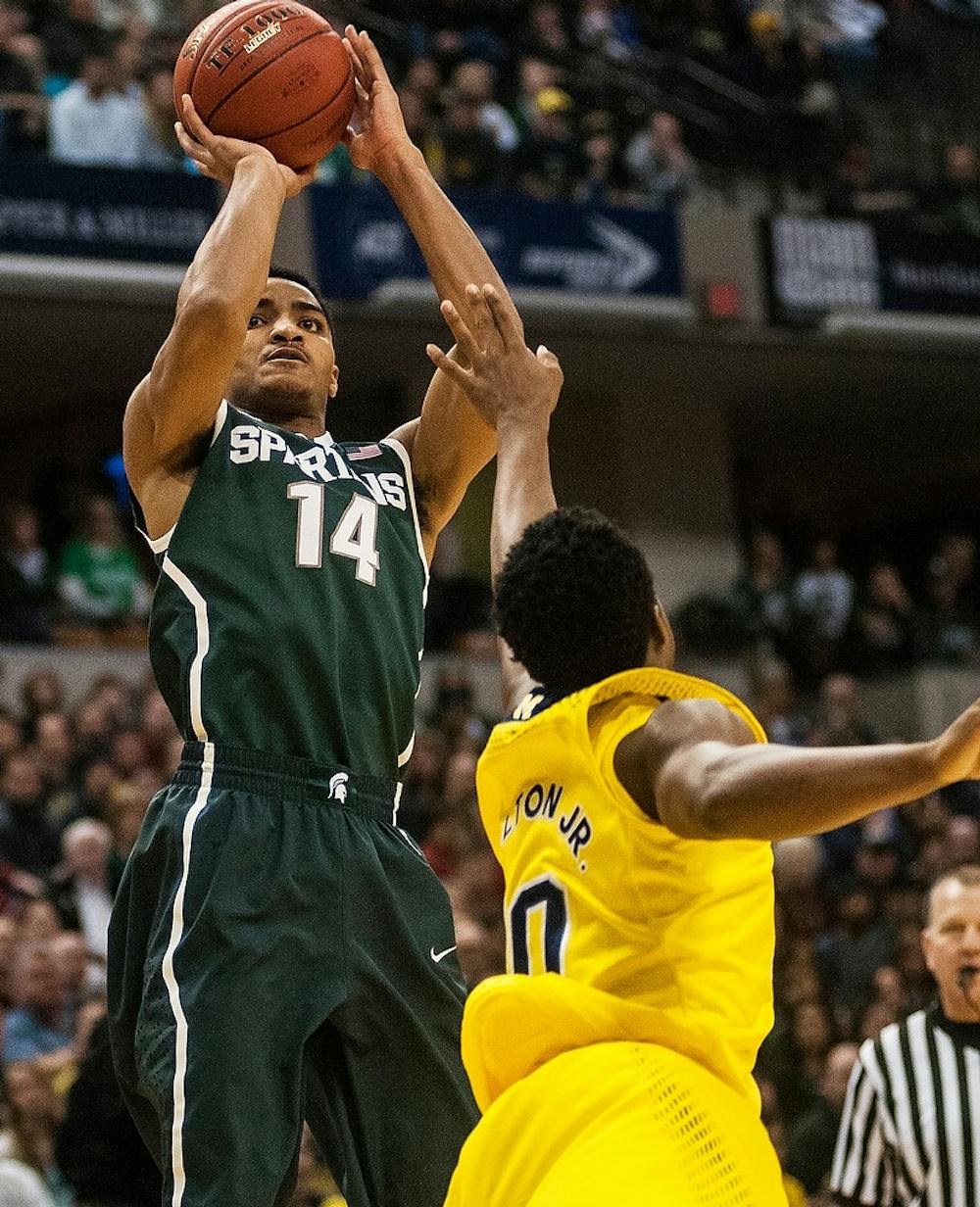 <p>Sophomore guard Gary Harris attempts a point over Michigan guard Derrick Walton Jr. on March 16, 2014, during the final against Michigan at the Big 10 Championship at Bankers Life Fieldhouse in Indianapolis. The Spartans won, 69-55. Erin Hampton/The State News</p>