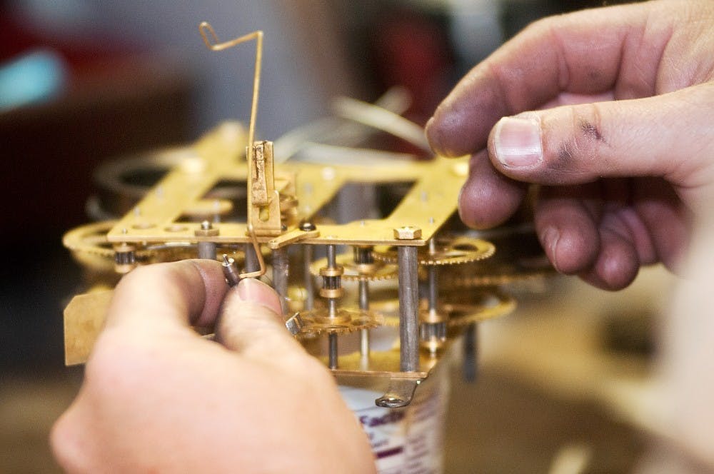 	<p>Lansing resident Glenn Williams works on a clock in the basement of his home May 20, 2013. Williams started his business, Tenor Clock, in January 2013, after a grandfather clock built by his father-in-law was in need of repair. Danyelle Morrow/The State News</p>