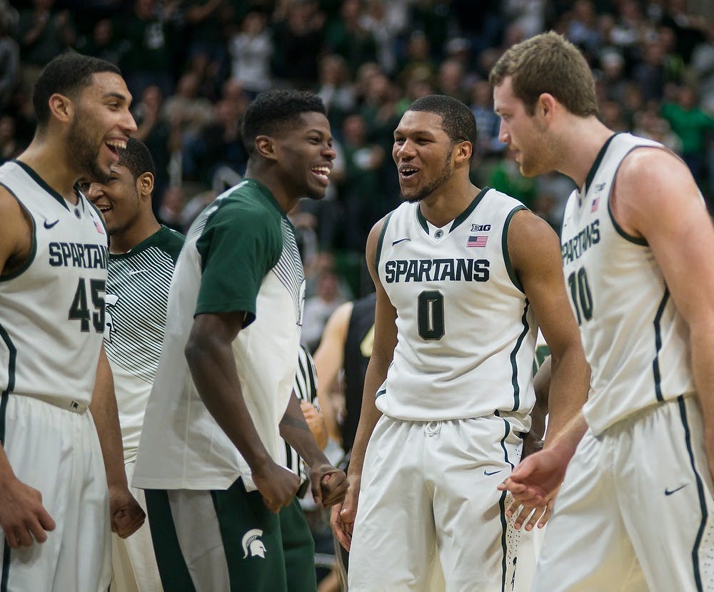 <p>Junior guard Denzel Valentine, junior guard Eron Harris,  freshman forward Marvin Clark Jr. and junior forward Matt Costello celebrate Costello's basket Mar. 4, 2015, during the game against Purdue at Breslin Center. The Spartans defeated the Boilermakers, 72-66. Emily Nagle/The State News</p>