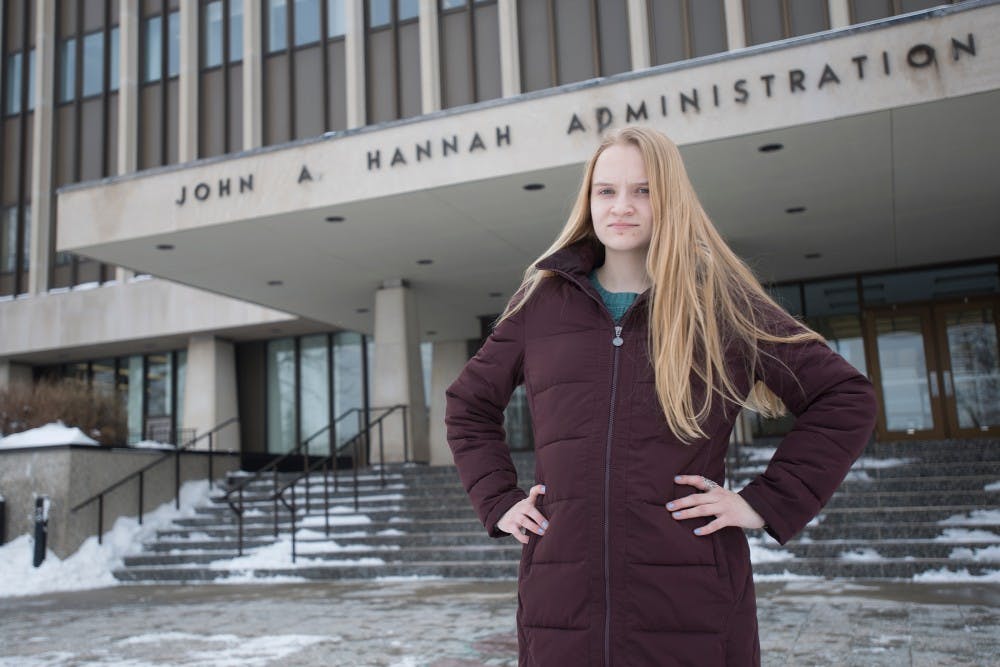 <p>Social relations & policy senior Emily Kollaritsch poses for a portrait Tuesday in front of the Hannah Administration Building, 426 Auditorium Road in East Lansing. Kollaritsch serves as an advocate for survivors of sexual assault to bring about change at the university. Emily Nagle/The State News</p>