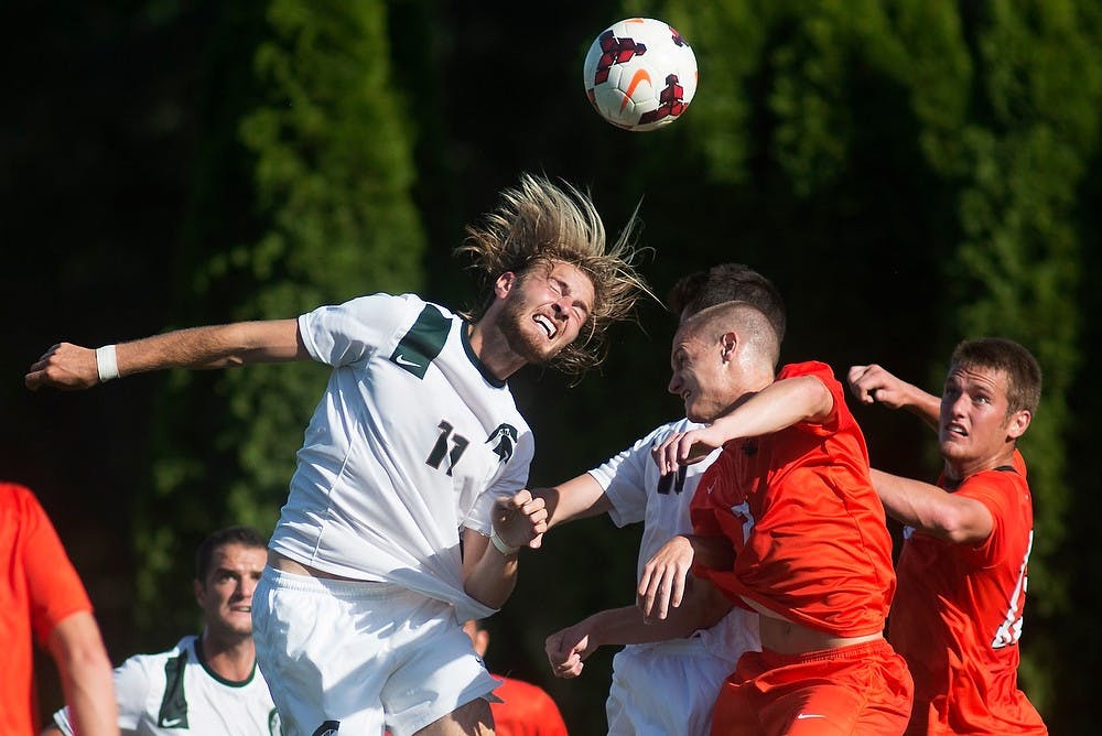 	<p>Junior defender Ryan Keener and Oregon State midfielder/defender Josh Smith go to headbutt the ball on Sept. 6, 2013, at DeMartin Stadium at Old College Field. The Spartans defeated the Beavers, 1-0. Julia Nagy/The State News </p>