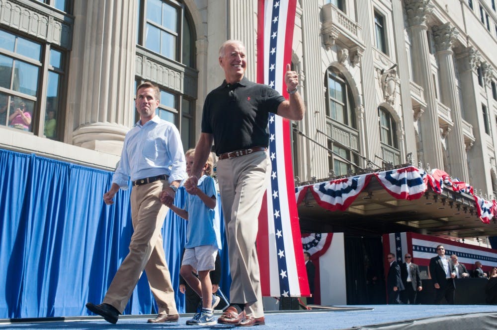 <p>Vice President Joe Biden, right, walks on stage with his grandson Hunter Biden, 6, center, and his son Beau Biden, left, attorney general of Delaware on Monday, Sept. 3, 2012 in downtown Detroit. Justin Wan/The State News</p>