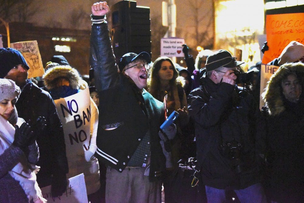 East Lansing resident Bruce Barker leads a chant on Jan. 31, 2017 at The Rock. The Michigan State Muslim Students' Association hosted a "No Ban, No Wall: Spartans for Sanctuary and Solidarity" as a response to President Trump's executive order on immigrants and refugees. 