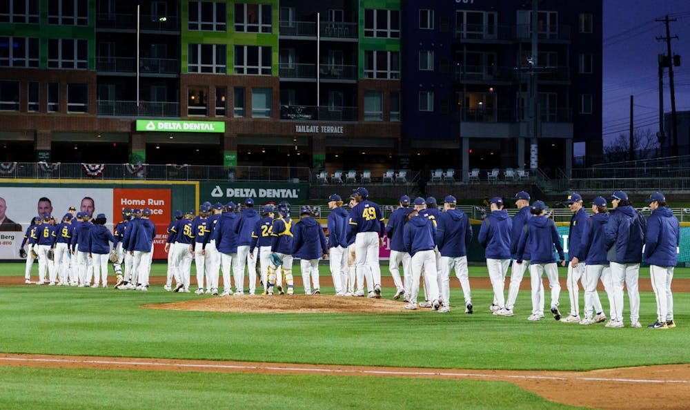 <p>The whole Michigan team walks onto the field to celebrate after the end of the ninth inning walking away victorious against the Spartans. Michigan State lost 18-6 to Michigan on April 15, 2022 at the Lugnut Stadium.<br/></p>