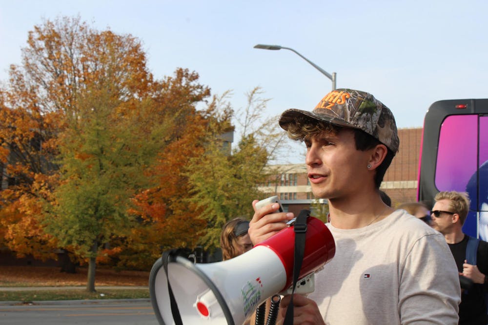 MSU Democrats president Liam Richichi leads early voting march to the Communication Arts and Sciences building polls at WKAR Studios