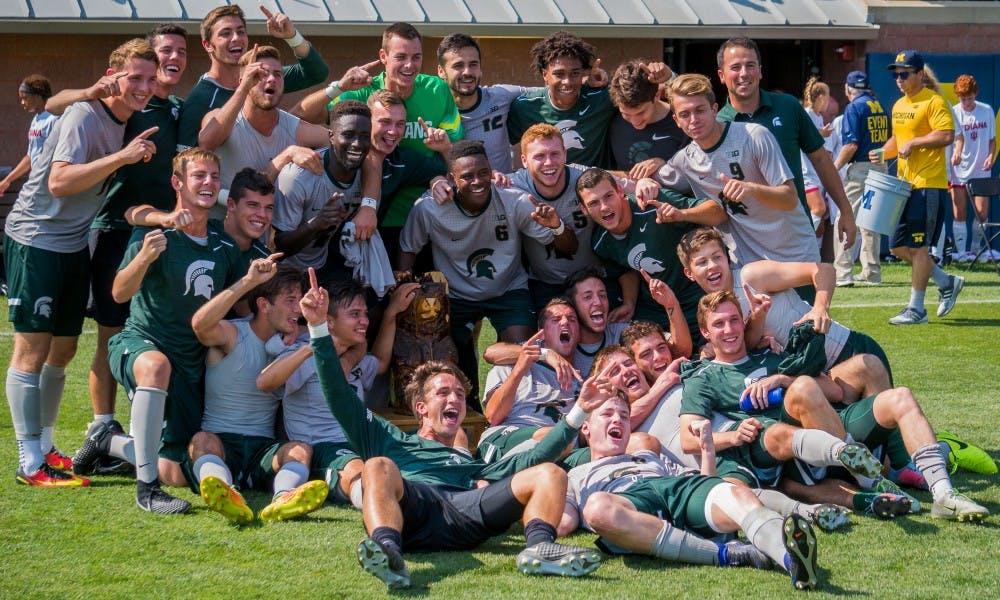 The Spartans pose for a picture with the Big Bear Trophy after the game against the University of Michigan on Sept. 17, 2017 at U-M Soccer Stadium. The Spartans defeated the Wolverines, 1-0.