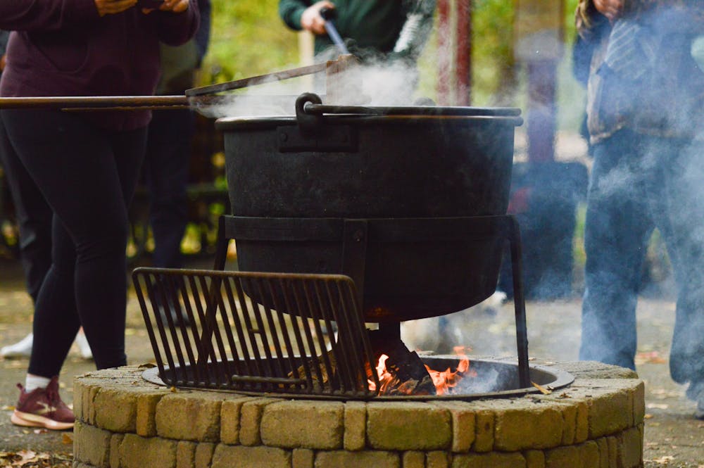<p>Volunteers allowed passerby to use the stir paddle to make apple butter in the kettle during the annual Apple Butter Festival on Oct. 16, 2022. The Apple Butter festival was held at the Fenner Nature Center on Oct. 15-16, 2022.﻿</p>