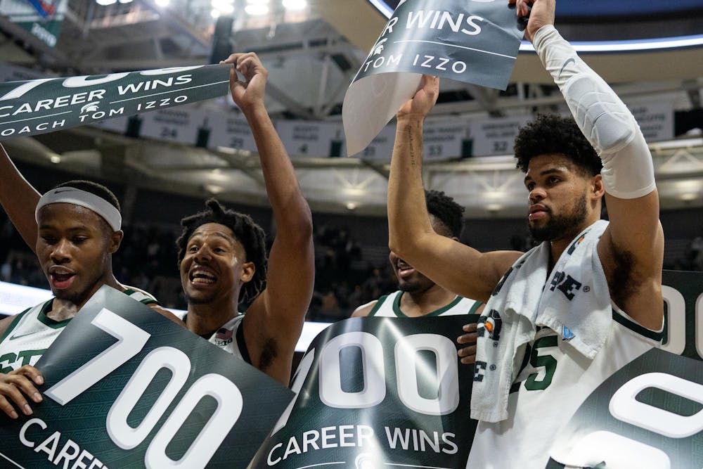 <p>The MSU men's basketball team cheers with head coach Tom Izzo as he celebrates 700 career wins after a victory against University of Michigan at the Breslin Student Events Center on Jan. 30, 2024.</p>