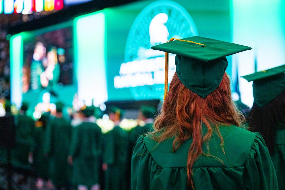 An MSU alumnus waits in line to receive her diploma during the fall 2024 commencement ceremony at the Breslin Center on Dec. 14, 2024.