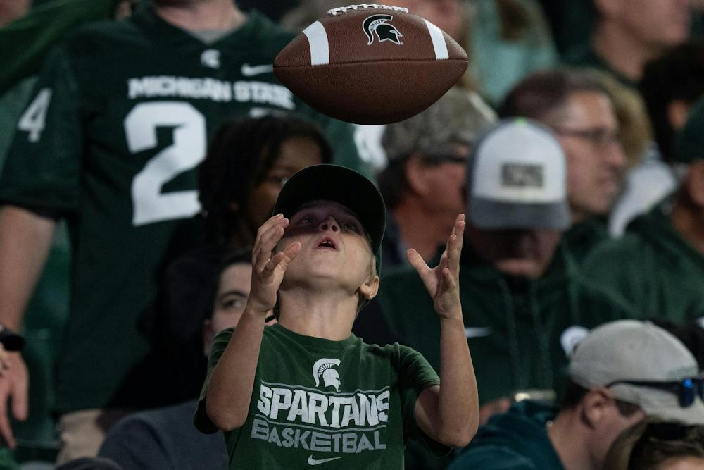 <p>A  fan throws a football while watching Michigan State’s game against Nebraska at Spartan Stadium in East Lansing, Mich., on Saturday, Sept. 26, 2026.</p>