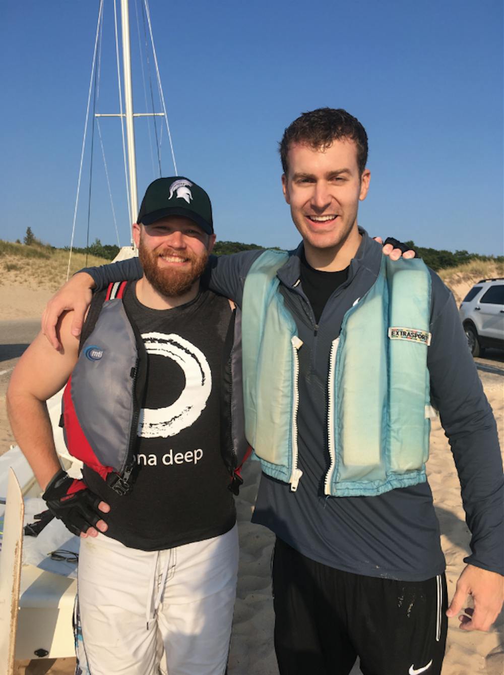 <p>J.T. Bohland (left) and Drew Fries (right) after they finished sailing 65-miles across Lake Michigan. Photo courtesy of Drew Fries&nbsp;</p>