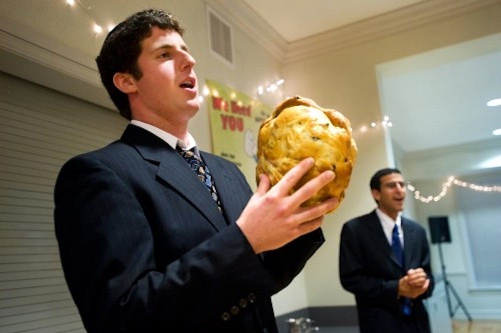 <p>Rabbi Dan Horwitz of West Bloomfield says a prayer as he holds two loaves of challah bread during the Rosh Hashanah, or Jewish New Year, celebration at Hillel Jewish Student Center on Sept. 28, 2011. The dinner featured traditional Jewish food, like challah and matzah ball soup.</p>
<p><strong>State News File Photo</strong></p>